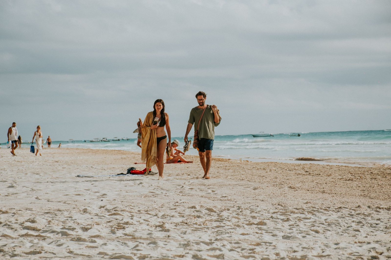 Two adults enjoying a walk by the ocean